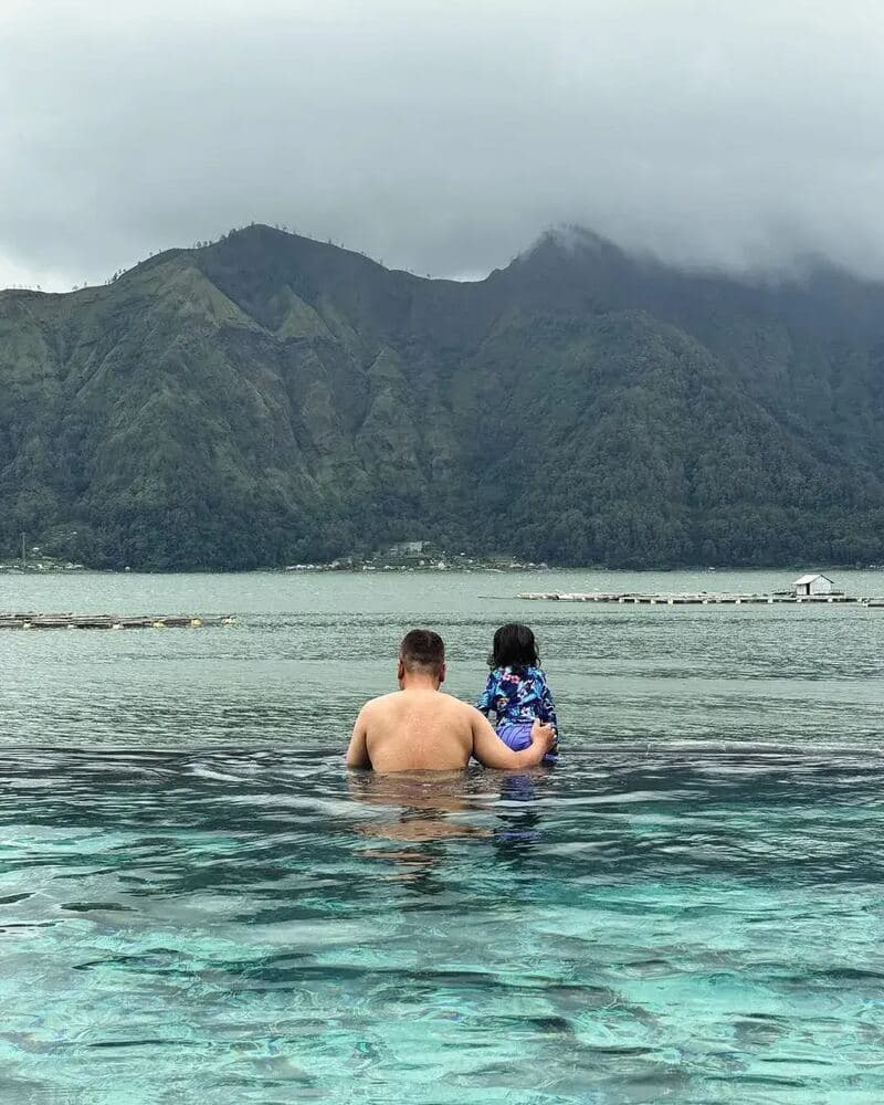 A family enjoying a calm day beside a Bali crater lake